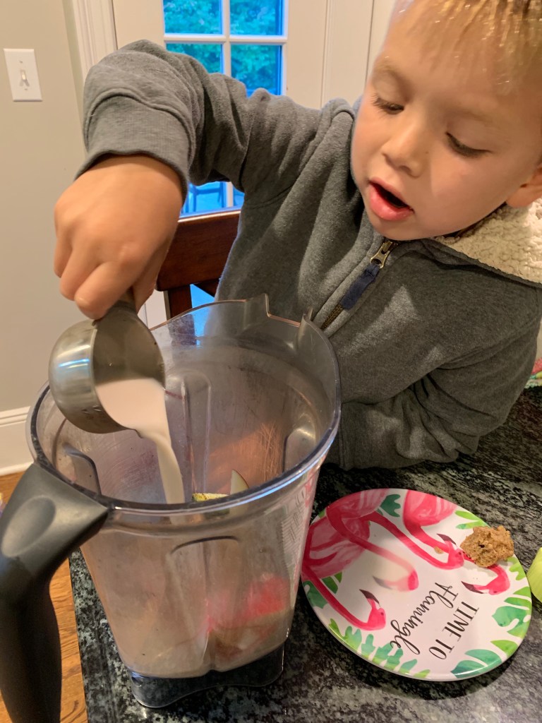 Kids helping make a smoothie